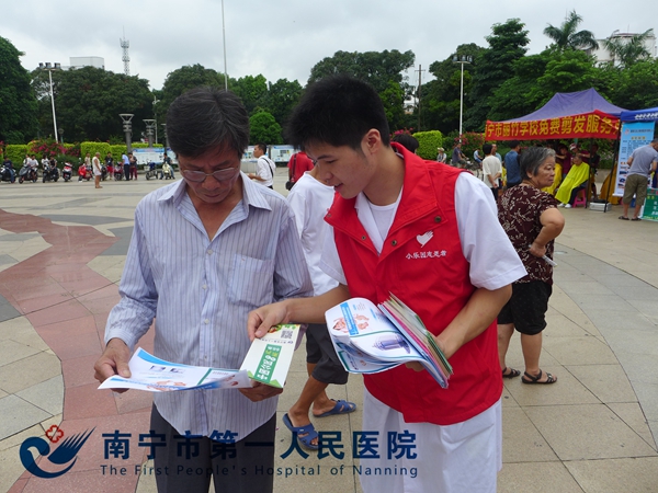 3、图为志愿者向群众发放健康宣传手册.JPG